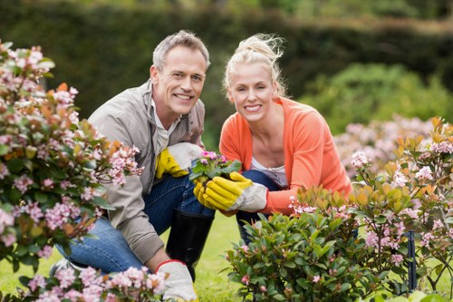 Gardeners practicing sustainable gardening methods